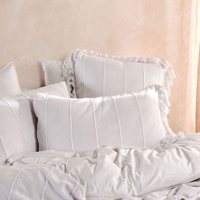 Brenda Bed Cover Set - A white bed cover with raised stripe detail and macrame fringe, accompanied by two coordinating pillowcases. Made of 100% cotton, it is fresh and stylish, and ideal for use all year round. Brought to you by Linen House for top quality bedding.